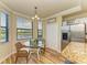 Bright breakfast nook with glass table and wicker chairs near the kitchen at 7005 River Hammock Dr # 103, Bradenton, FL 34212