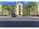 Condo building entrance with lush landscaping at 7005 River Hammock Dr # 103, Bradenton, FL 34212