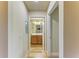 Light and bright hallway with wood flooring and access to bathroom at 7005 River Hammock Dr # 103, Bradenton, FL 34212