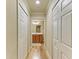 Hallway with light wood flooring and built in storage at 7005 River Hammock Dr # 103, Bradenton, FL 34212