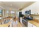 Open concept kitchen with stainless steel appliances and granite countertops at 7005 River Hammock Dr # 103, Bradenton, FL 34212