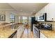 Bright kitchen featuring stainless steel appliances and granite countertops at 7005 River Hammock Dr # 103, Bradenton, FL 34212