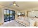 Bright living room with water views, comfortable seating, and access to a balcony at 7005 River Hammock Dr # 103, Bradenton, FL 34212