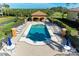 Resort-style pool with lounge chairs and a shaded area at 7005 River Hammock Dr # 103, Bradenton, FL 34212