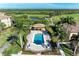 Community pool with lush landscaping at 7005 River Hammock Dr # 103, Bradenton, FL 34212