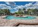 Resort-style pool with lounge chairs and landscaping at 7005 River Hammock Dr # 103, Bradenton, FL 34212