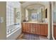 Elegant bathroom with double vanity, soaking tub, and large mirror at 7416 Birds Eye Ter, Bradenton, FL 34203