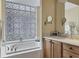 Primary bathroom with double vanity and a soaking tub at 7416 Birds Eye Ter, Bradenton, FL 34203