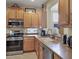 Well-equipped kitchen featuring wood cabinets and stainless steel appliances at 7416 Birds Eye Ter, Bradenton, FL 34203