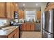 Modern kitchen with wood cabinets and stainless steel appliances at 7416 Birds Eye Ter, Bradenton, FL 34203