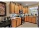 Modern kitchen with stainless steel appliances and wood cabinets at 7416 Birds Eye Ter, Bradenton, FL 34203