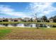 View of pond and houses from across the water at 7416 Birds Eye Ter, Bradenton, FL 34203
