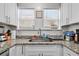 White shaker cabinets, granite countertops, and stainless steel sink at 766 13Th S Ave, St Petersburg, FL 33701