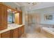 Elegant bathroom with soaking tub, walk-in shower, and double vanity at 805 Riviera Dunes Way, Palmetto, FL 34221