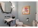 Elegant powder room with unique vessel sink and art at 805 Riviera Dunes Way, Palmetto, FL 34221