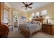 Bright bedroom with a ceiling fan and en suite bathroom at 805 Riviera Dunes Way, Palmetto, FL 34221