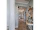 Elegant hallway with ornate mirror and access to Primary bath at 805 Riviera Dunes Way, Palmetto, FL 34221