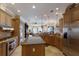 Spacious kitchen with island, breakfast bar, stainless steel appliances, and tile floors at 805 Riviera Dunes Way, Palmetto, FL 34221