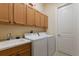 Laundry room with washer, dryer, and ample cabinet space at 805 Riviera Dunes Way, Palmetto, FL 34221