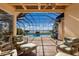 Spacious pool area with covered patio and seating at 805 Riviera Dunes Way, Palmetto, FL 34221