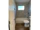 Updated bathroom with a bathtub, toilet and gray tile at 820 32Nd E St, Palmetto, FL 34221