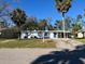 Cute ranch home with palm trees, a carport and a blue front door at 820 32Nd E St, Palmetto, FL 34221