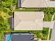 Aerial view showcasing the house roof, landscaping, and pool at 8412 Whispering Woods Ct, Lakewood Ranch, FL 34202