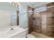 Bathroom with modern sink and walk-in shower with decorative tile at 8412 Whispering Woods Ct, Lakewood Ranch, FL 34202