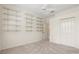 A bright carpeted bedroom with a ceiling fan, shelving, and double door closet at 8412 Whispering Woods Ct, Lakewood Ranch, FL 34202