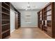 Spacious bedroom showcasing hardwood floors, a ceiling fan, and built-in bookshelves at 8412 Whispering Woods Ct, Lakewood Ranch, FL 34202