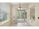 Dining area with a sliding glass door, providing natural light and access to the screened lanai at 8412 Whispering Woods Ct, Lakewood Ranch, FL 34202