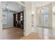 View of the foyer and the office space featuring hard wood floors, a ceiling fan, and built-in bookshelves at 8412 Whispering Woods Ct, Lakewood Ranch, FL 34202