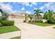 Charming single Gathering home with a two-car garage, mature landscaping, and a well-manicured lawn at 8412 Whispering Woods Ct, Lakewood Ranch, FL 34202