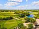 Spectacular aerial view of the lush green golf course with ponds, trees, and beautiful landscaping at 8412 Whispering Woods Ct, Lakewood Ranch, FL 34202