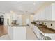 Eat-in kitchen with granite countertops, white cabinetry and a breakfast bar at 8412 Whispering Woods Ct, Lakewood Ranch, FL 34202