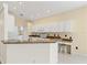 Charming eat-in kitchen with granite countertops, white cabinetry, and a breakfast bar at 8412 Whispering Woods Ct, Lakewood Ranch, FL 34202