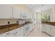 Bright kitchen with white cabinets, granite countertops, and stainless steel appliances at 8412 Whispering Woods Ct, Lakewood Ranch, FL 34202