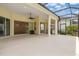 Large screened lanai with ample space for outdoor furniture, dining, and a cozy fireplace at 8412 Whispering Woods Ct, Lakewood Ranch, FL 34202