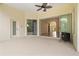 Covered lanai featuring a fireplace and a screen enclosure with views into the home's living area at 8412 Whispering Woods Ct, Lakewood Ranch, FL 34202