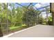 Screened lanai showing the backyard lush landscaping and mature trees at 8412 Whispering Woods Ct, Lakewood Ranch, FL 34202