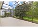 Screened lanai showcasing the surrounding trees and backyard at 8412 Whispering Woods Ct, Lakewood Ranch, FL 34202