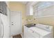 Laundry room equipped with washer, dryer and storage at 8412 Whispering Woods Ct, Lakewood Ranch, FL 34202
