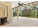 Screened-in patio with a fireplace and views of the trees at 8412 Whispering Woods Ct, Lakewood Ranch, FL 34202