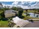 Yellow house with three-car garage, pond view at 9351 Raes Creek Pl, Palmetto, FL 34221