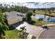 Aerial view of a single-Gathering home with a pond and golf course in the background at 9351 Raes Creek Pl, Palmetto, FL 34221