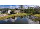 Aerial view of a yellow house with pool and pond at 9351 Raes Creek Pl, Palmetto, FL 34221