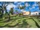 Landscaped backyard with lush lawn and tropical plants at 9351 Raes Creek Pl, Palmetto, FL 34221