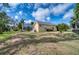 Landscaped backyard with lush lawn and tropical plants at 9351 Raes Creek Pl, Palmetto, FL 34221