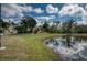 Landscaped backyard with pond view and lush greenery at 9351 Raes Creek Pl, Palmetto, FL 34221