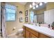 Bathroom with single vanity, shower/tub combo and decorative accents at 9351 Raes Creek Pl, Palmetto, FL 34221
